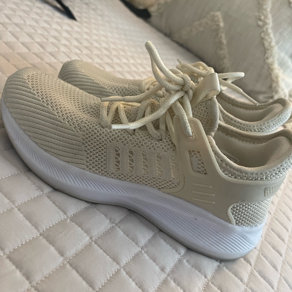 Cream athletic shoes